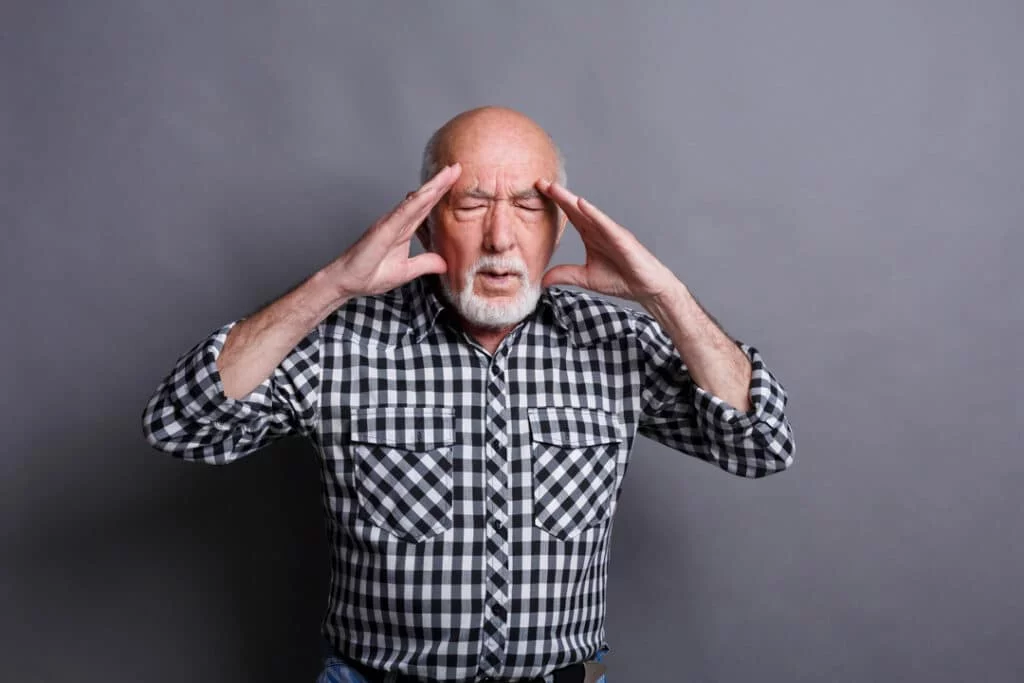 concentrated-senior-man-thinking-about-something-holding-fingers-temple-gray-studio-background-brainstorm-bad-memory-headache-concept-copy-space